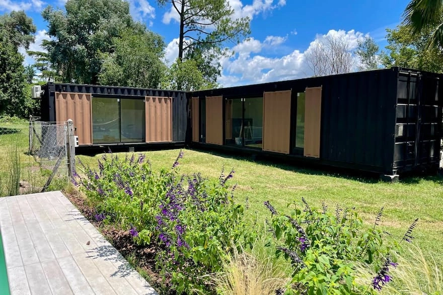 Vivienda de aspecto modular con revestimientos oscuros y madera